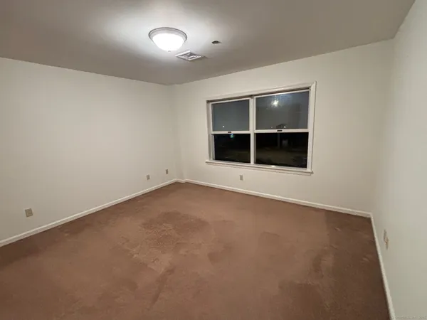 an empty room with a empty space and window