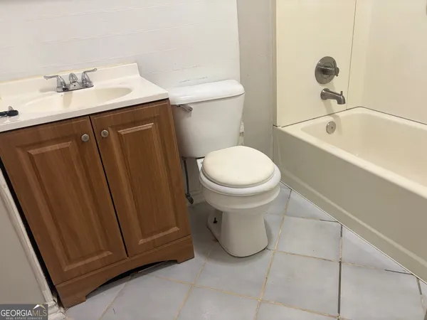 a bathroom with a sink a toilet and bathtub