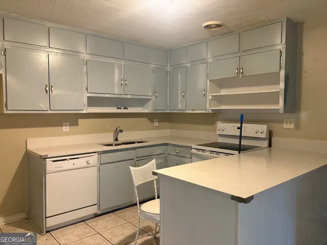 a kitchen with a sink cabinets and window