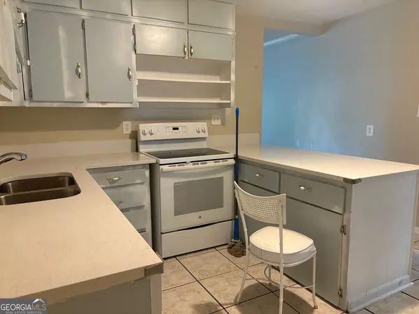 a kitchen with a stove cabinets and a sink