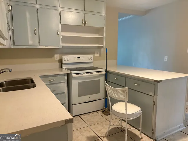 a kitchen with a stove cabinets and a sink