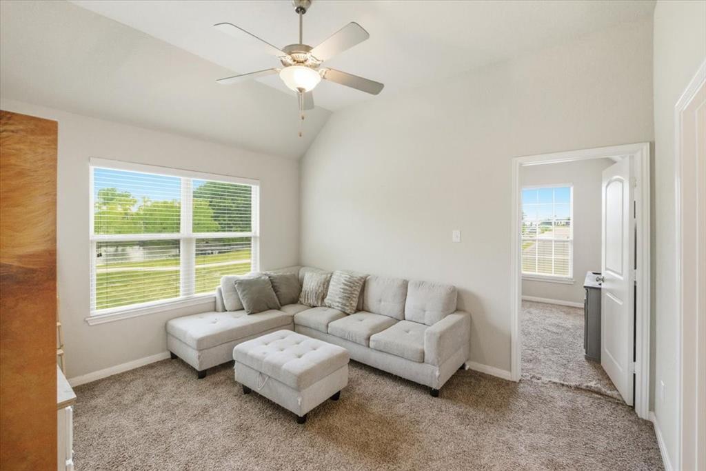 10701 Kestrel Court Waco, TX 76708 - Photo 11 of 37 Second living area featuring a ceiling fan, carpet, and lofted ceiling