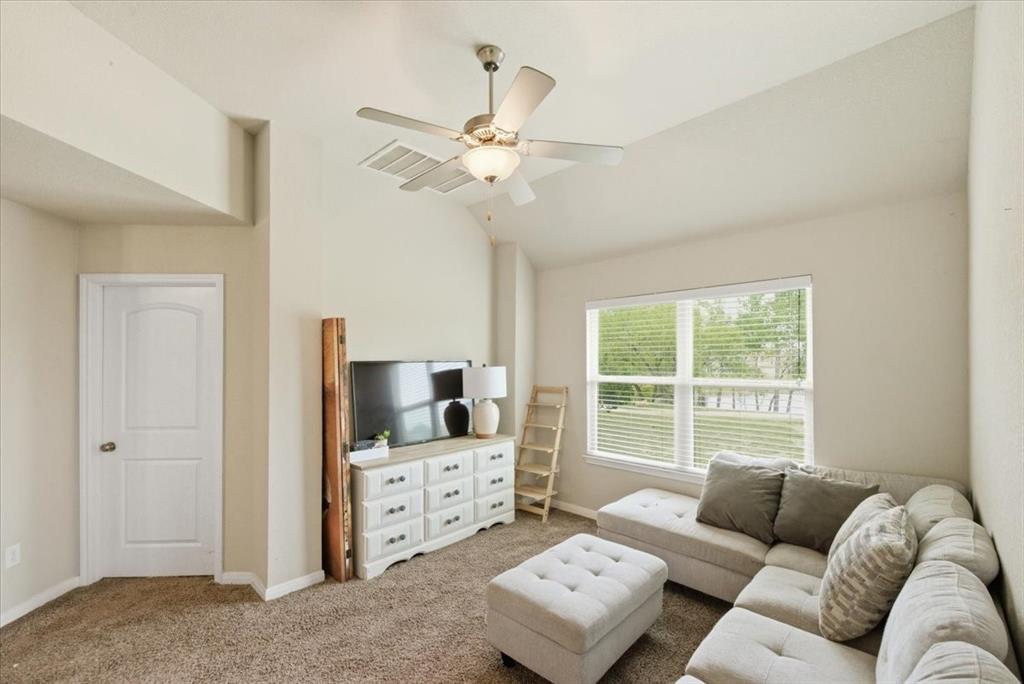 10701 Kestrel Court Waco, TX 76708 - Photo 12 of 37 Carpeted second living area featuring a ceiling fan and vaulted ceiling