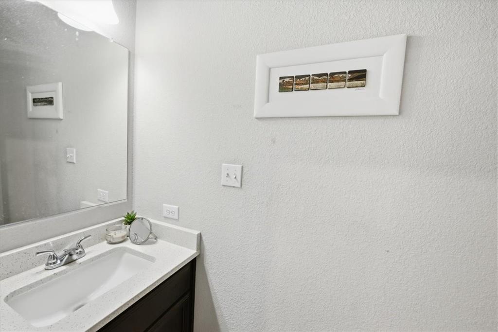 10701 Kestrel Court Waco, TX 76708 - Photo 18 of 37 Guest half-bathroom featuring vanity and commode