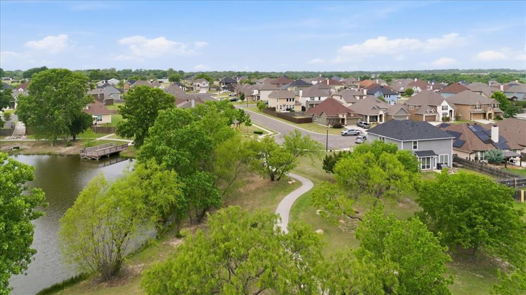10701 Kestrel Court Waco, TX 76708 - Photo 31 of 37 Aerial view of neighborhood pond, walking area, and this home on the right