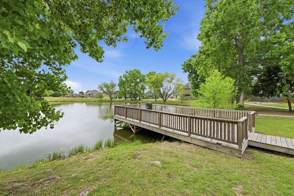 10701 Kestrel Court Waco, TX 76708 - Photo 34 of 37 View of the community pond with dock