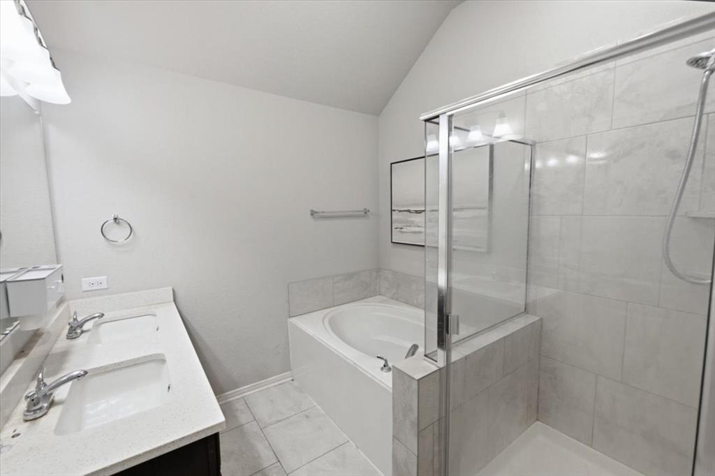 10701 Kestrel Court Waco, TX 76708 - Photo 9 of 37 Primary bathroom with double vanity, a bath, lofted ceiling, and a large, walk-in shower