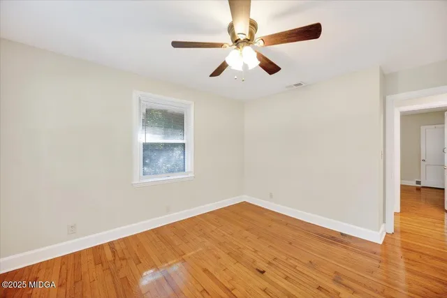 wooden floor in an empty room with a window