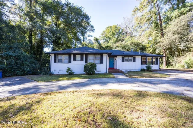 a view of house with outdoor space and swimming pool