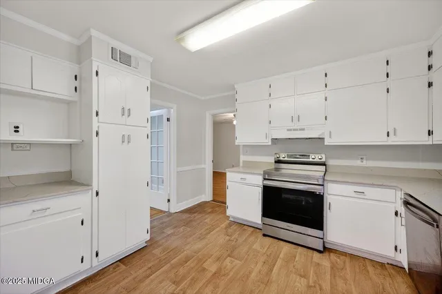 a kitchen with stainless steel appliances white cabinets and a sink