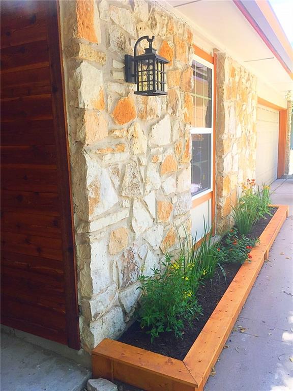 3305 Spaniel Drive Austin, TX 78759 - Photo 4 of 20 Crafted stone exterior welcomes with a refined wood planter box, adding verdant charm.