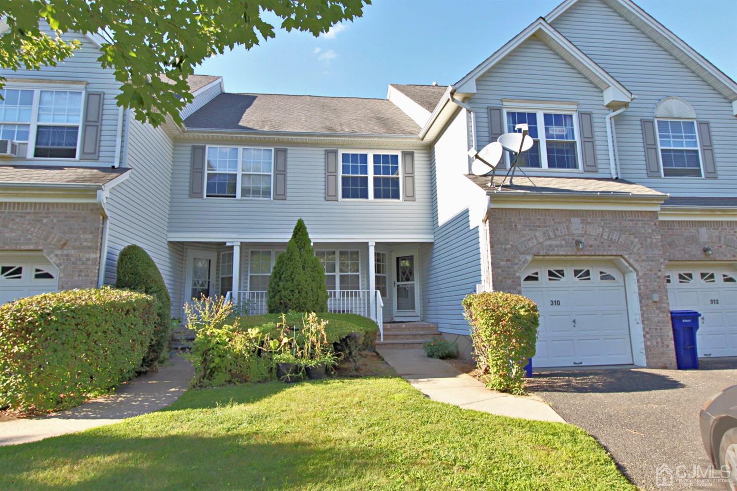 310 Hawthorne Road North Brunswick, NJ 08902 - Photo 1 of 25 a front view of a house with a yard and outdoor seating