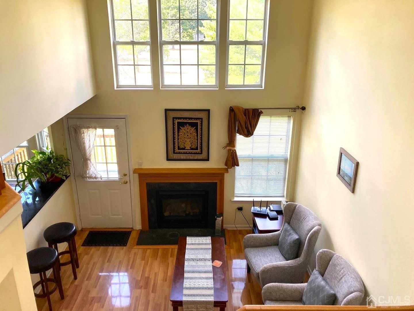 310 Hawthorne Road North Brunswick, NJ 08902 - Photo 14 of 25 a living room with furniture windows and a fireplace
