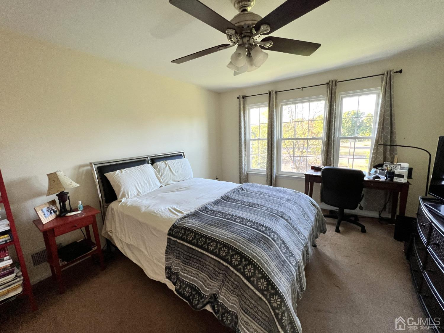 310 Hawthorne Road North Brunswick, NJ 08902 - Photo 16 of 25 a bedroom with a bed and a chandelier