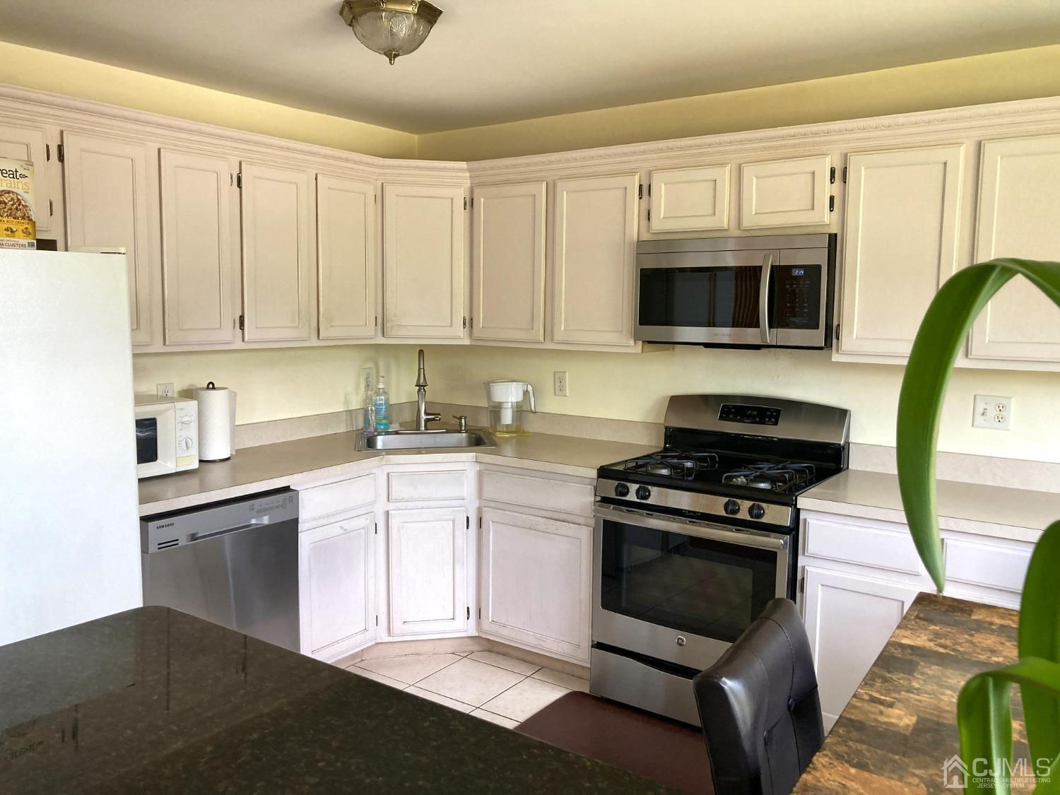 310 Hawthorne Road North Brunswick, NJ 08902 - Photo 4 of 25 a kitchen with stainless steel appliances granite countertop a stove and a sink