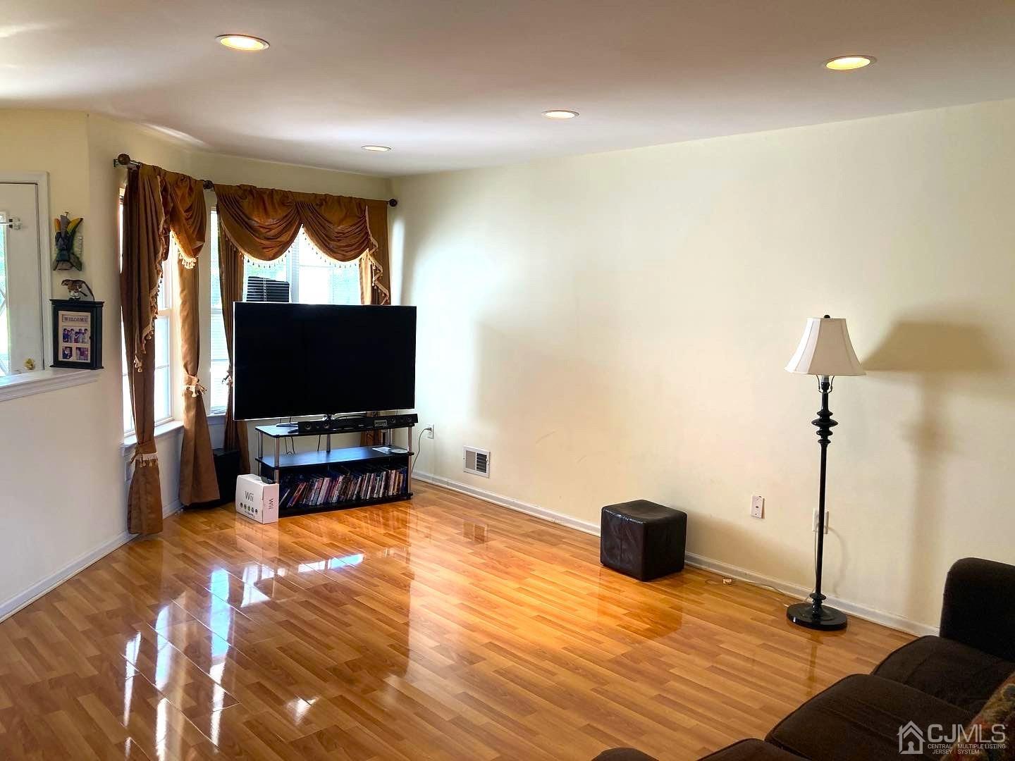 310 Hawthorne Road North Brunswick, NJ 08902 - Photo 9 of 25 a living room with furniture and a flat screen tv