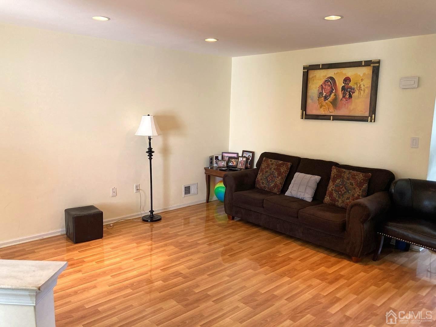 310 Hawthorne Road North Brunswick, NJ 08902 - Photo 10 of 25 a living room with furniture and a flat screen tv
