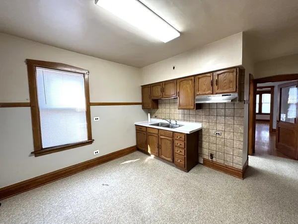 a kitchen with a refrigerator and a stove