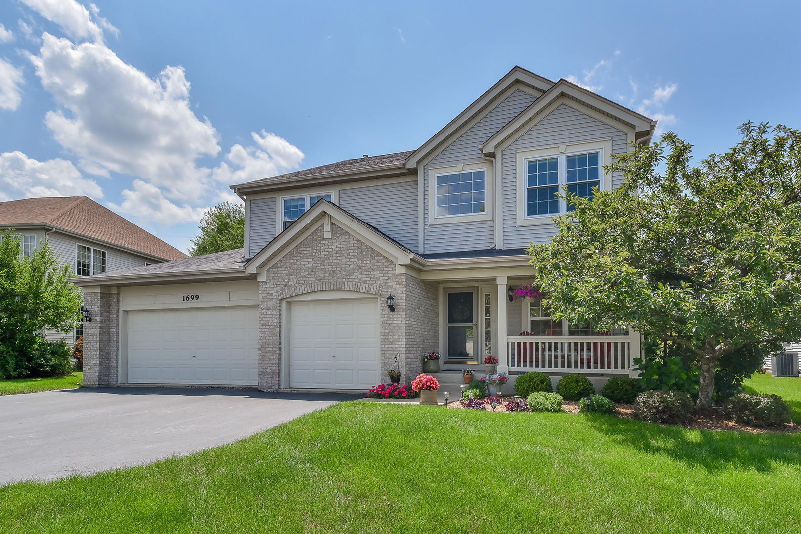 1699 Montclair Drive Elgin, IL 60123 - Photo 1 of 30 a front view of a house with a garden and plants