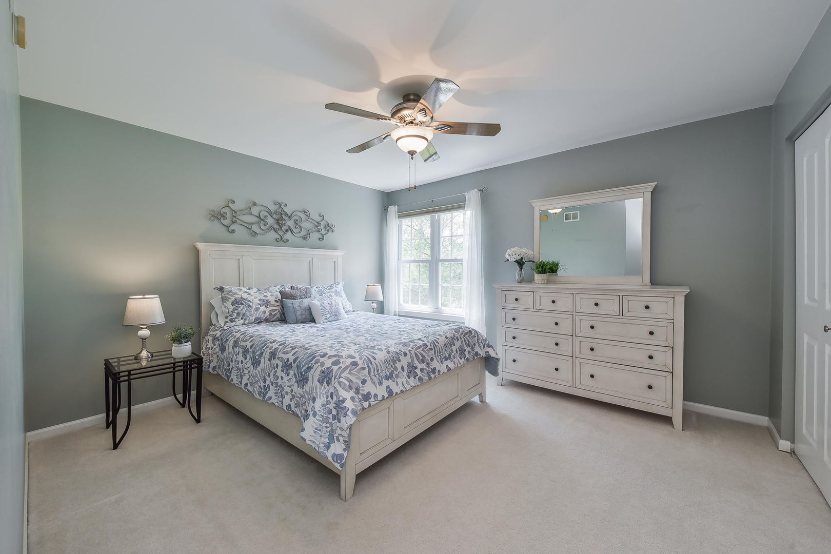 1699 Montclair Drive Elgin, IL 60123 - Photo 18 of 30 a bedroom with a bed a chandelier and a dresser