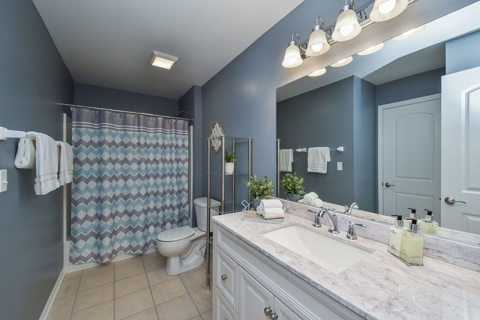 1699 Montclair Drive Elgin, IL 60123 - Photo 19 of 30 a bathroom with a double vanity sink mirror and toilet