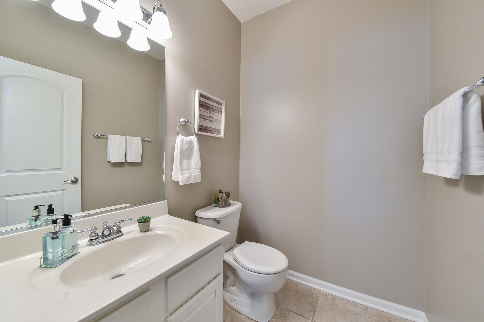 1699 Montclair Drive Elgin, IL 60123 - Photo 22 of 30 a bathroom with a sink vanity mirror and toilet