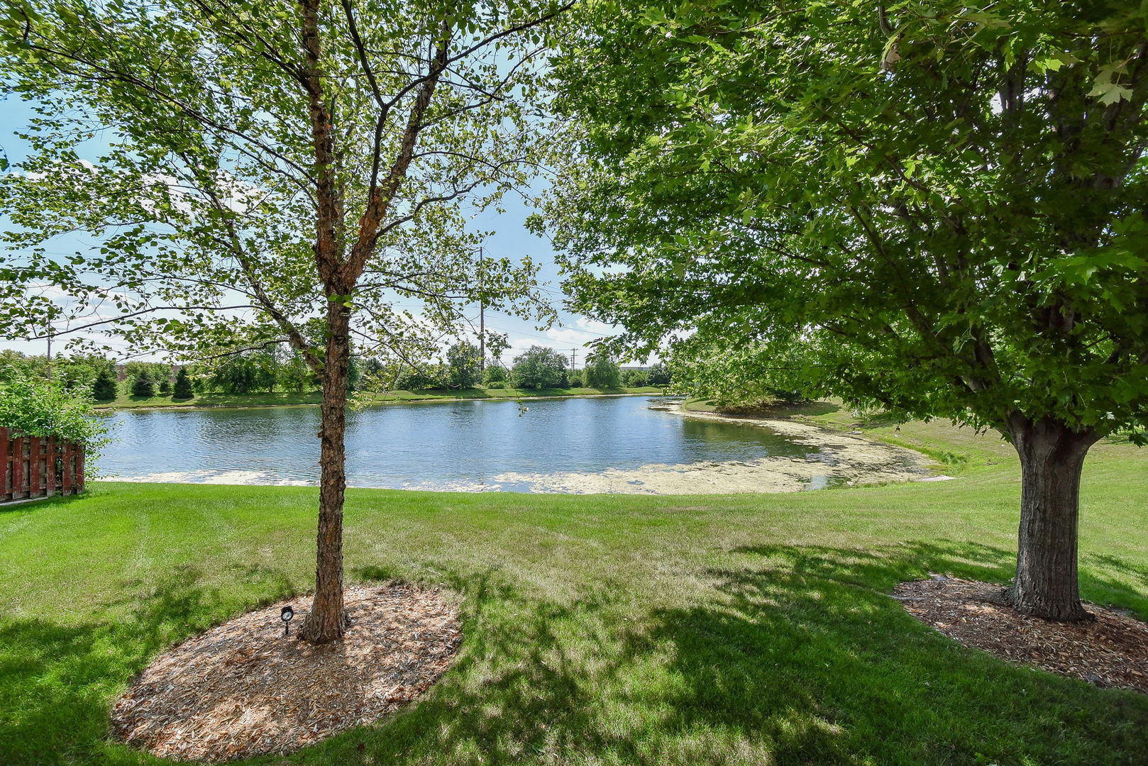 1699 Montclair Drive Elgin, IL 60123 - Photo 25 of 30 a view of a lake with a large trees