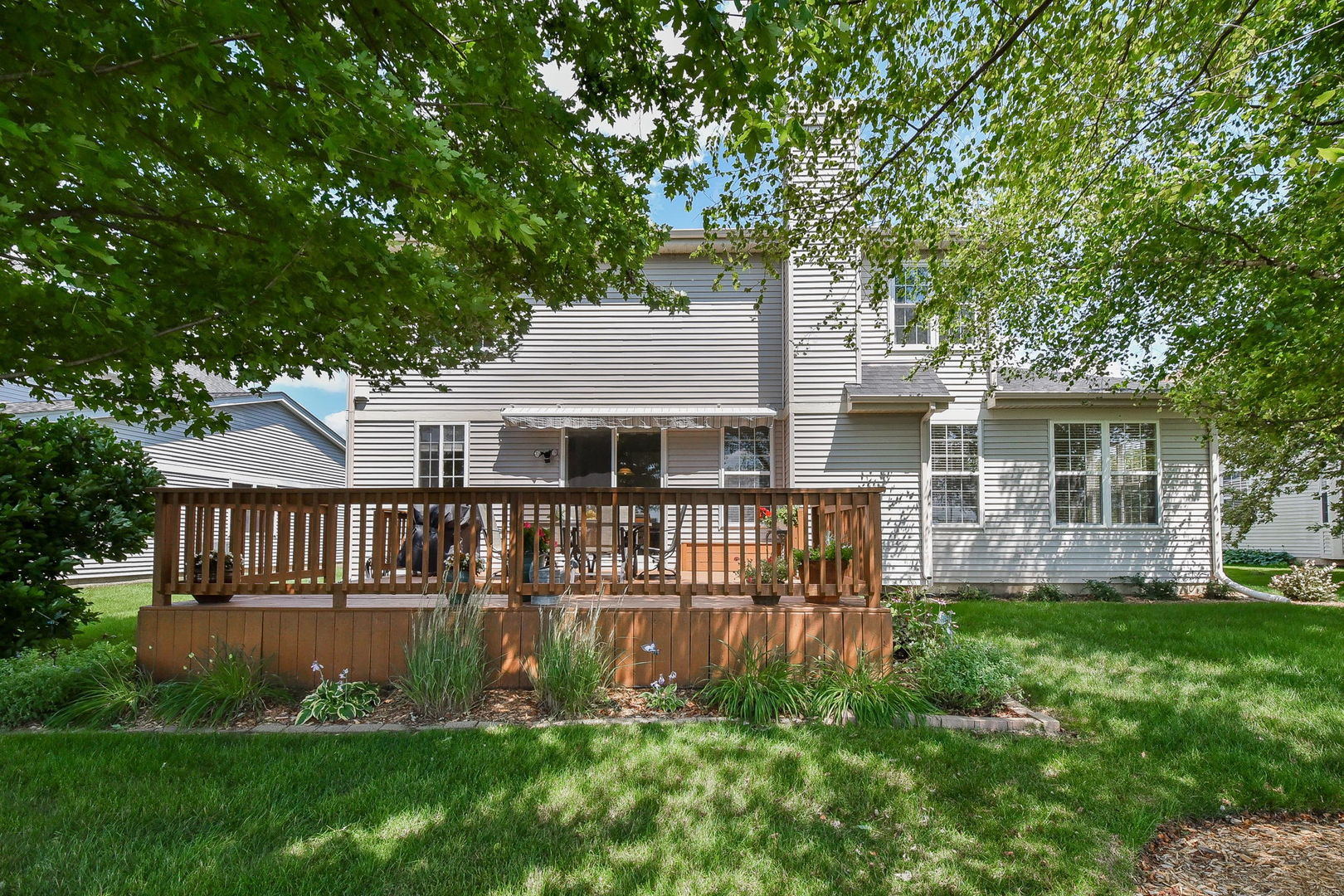1699 Montclair Drive Elgin, IL 60123 - Photo 26 of 30 a front view of a house with a garden and yard