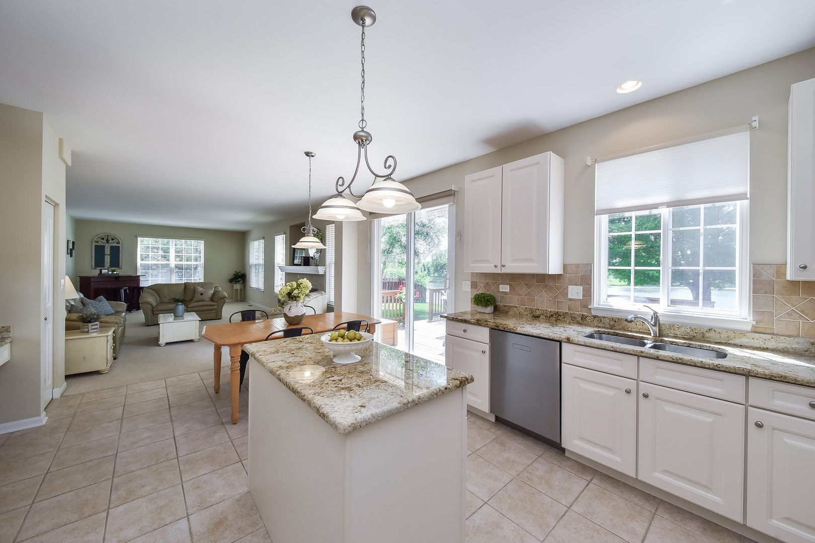 1699 Montclair Drive Elgin, IL 60123 - Photo 3 of 30 a open kitchen with a sink a stove and chairs