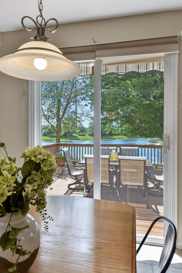 1699 Montclair Drive Elgin, IL 60123 - Photo 5 of 30 a dining room with furniture water view and a floor to ceiling window
