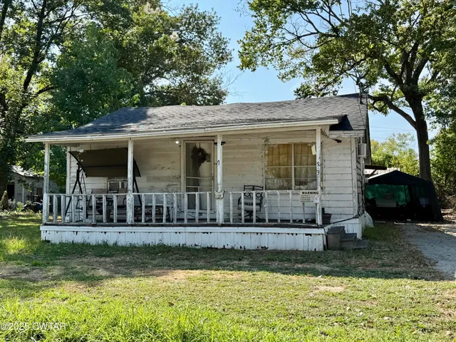 a view of house with yard in front of it