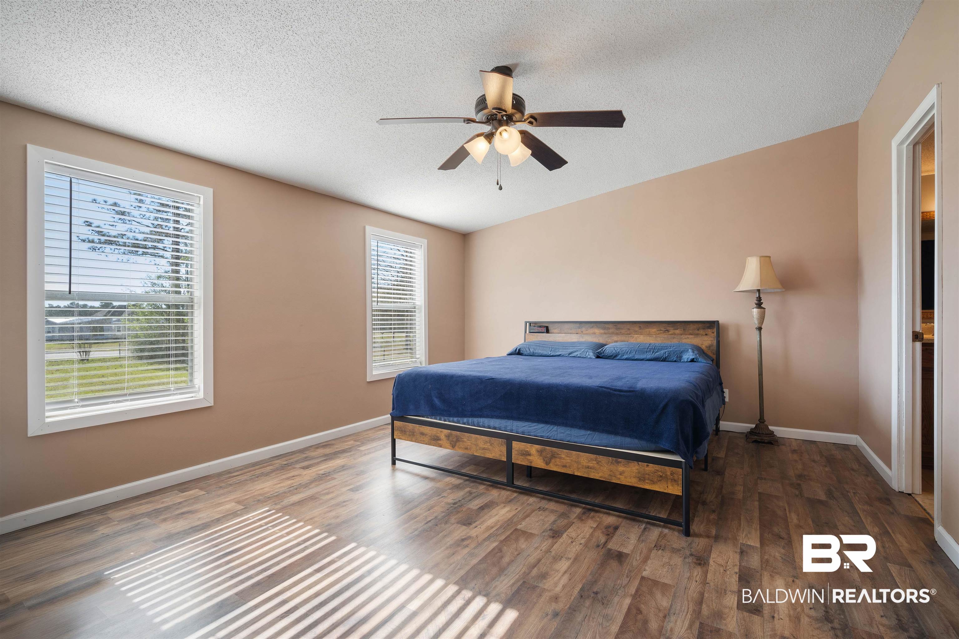 9011 Wilmer Georgetown Road Wilmer, AL 36587 - Photo 13 of 34 Bedroom with baseboards, a textured ceiling, wood finished floors, and ceiling fan