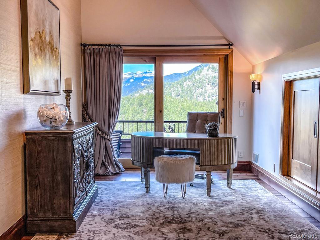 3731 Overlook Trail Evergreen, CO 80439 - Photo 21 of 35 a living room with furniture and a fireplace