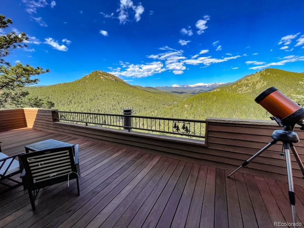 3731 Overlook Trail Evergreen, CO 80439 - Photo 22 of 35 a view of a balcony with wooden floor and outdoor seating