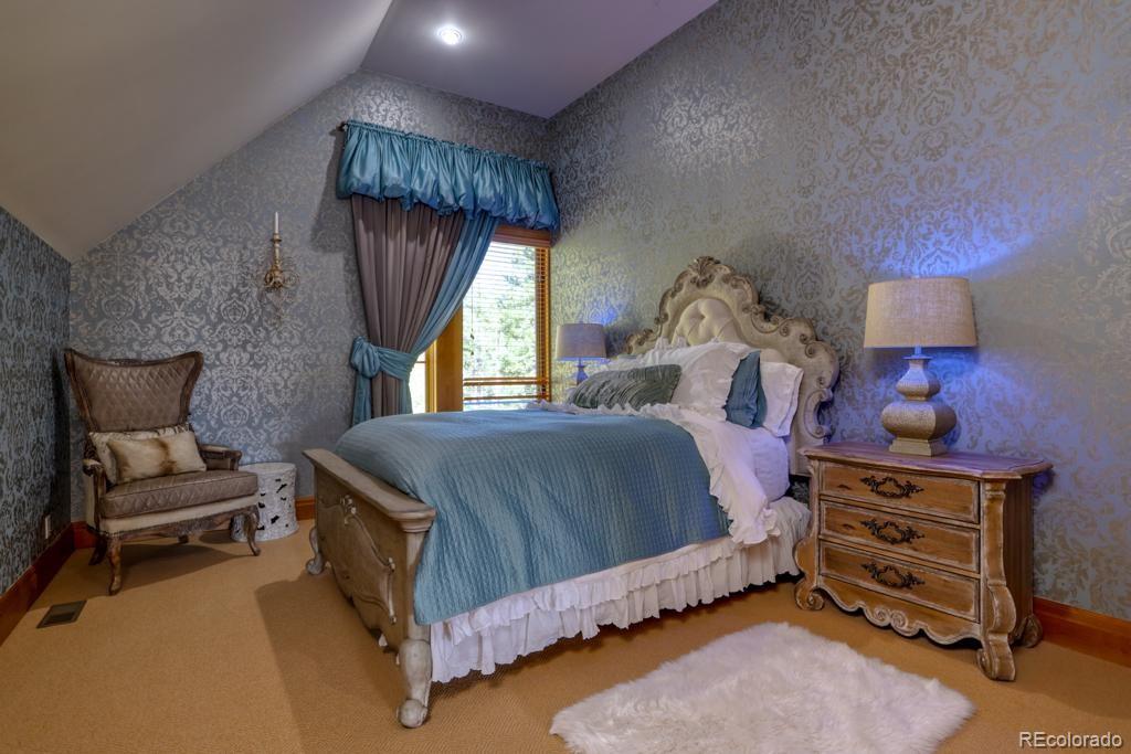 3731 Overlook Trail Evergreen, CO 80439 - Photo 25 of 35 a bedroom with a bed chair and window