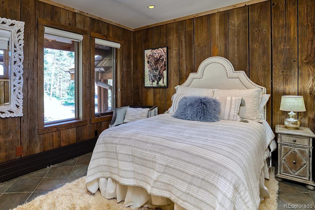 3731 Overlook Trail Evergreen, CO 80439 - Photo 29 of 35 a bedroom with a bed and a window