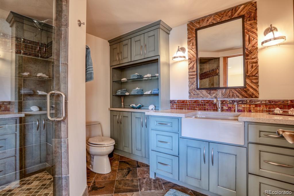 3731 Overlook Trail Evergreen, CO 80439 - Photo 31 of 35 a bathroom with a sink toilet and shower