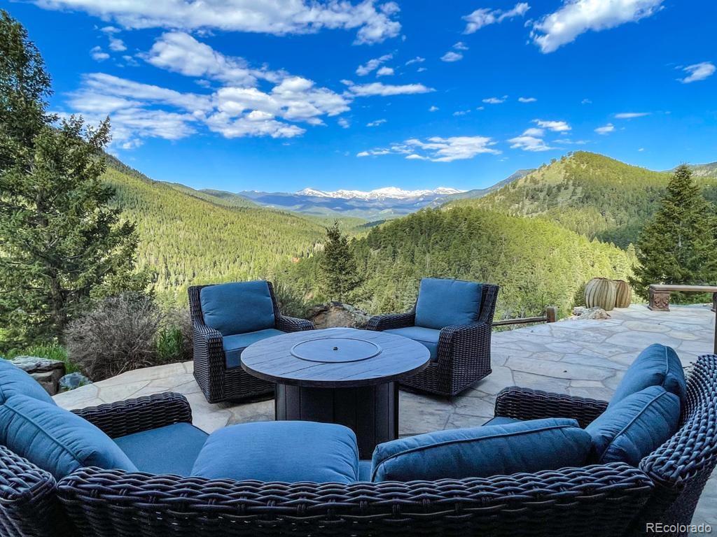 3731 Overlook Trail Evergreen, CO 80439 - Photo 32 of 35 a view of a couches and a table in the patio