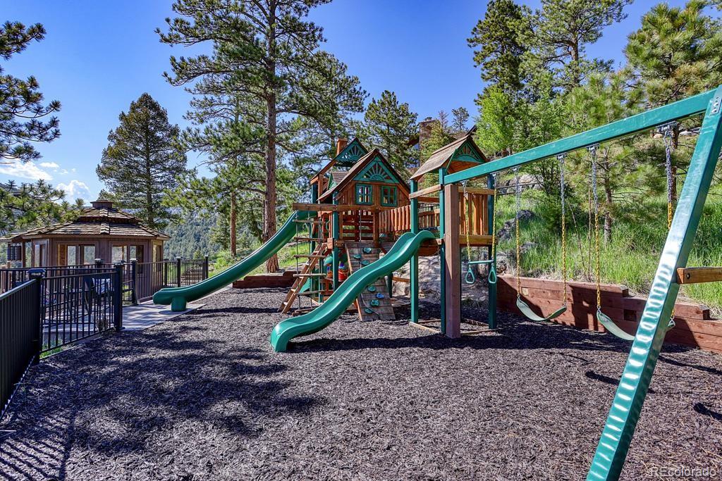 3731 Overlook Trail Evergreen, CO 80439 - Photo 34 of 35 a view of a house with a backyard and a wooden deck