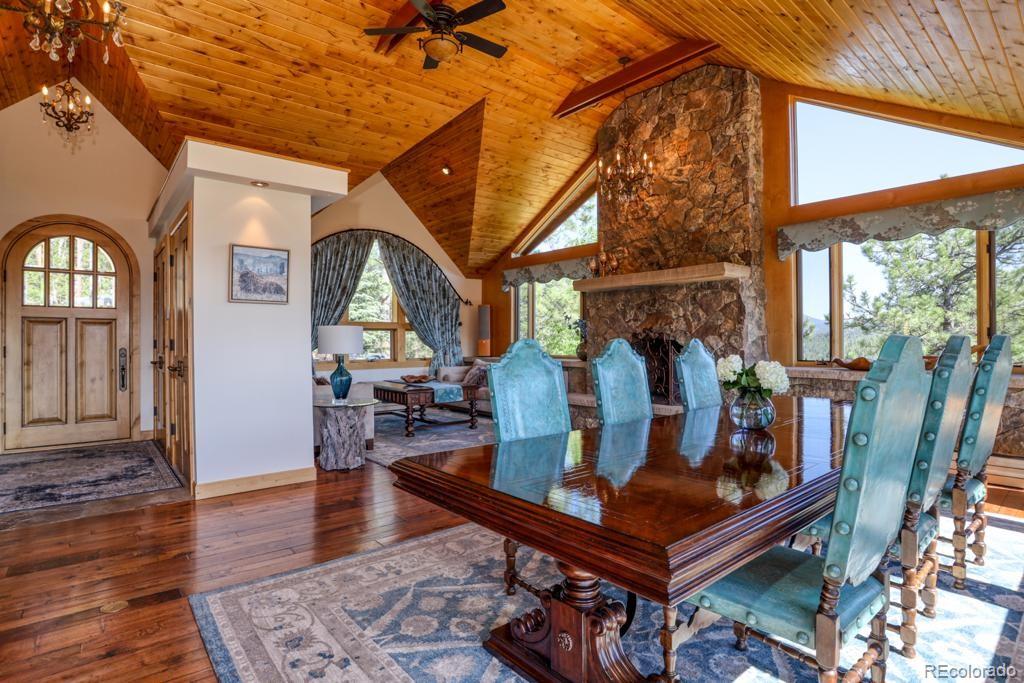 3731 Overlook Trail Evergreen, CO 80439 - Photo 4 of 35 a living room with furniture a piano and wooden floor