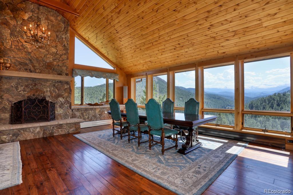 3731 Overlook Trail Evergreen, CO 80439 - Photo 5 of 35 a view of a dining room with furniture window and wooden floor