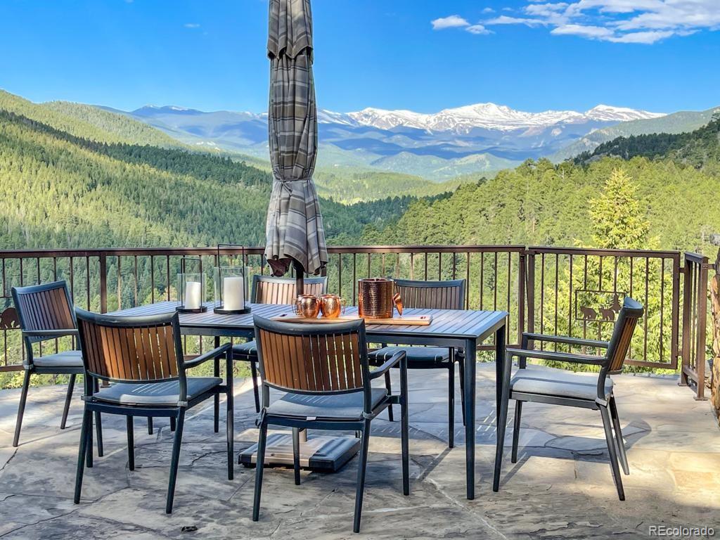 3731 Overlook Trail Evergreen, CO 80439 - Photo 10 of 35 a view of a chairs and table on the terrace