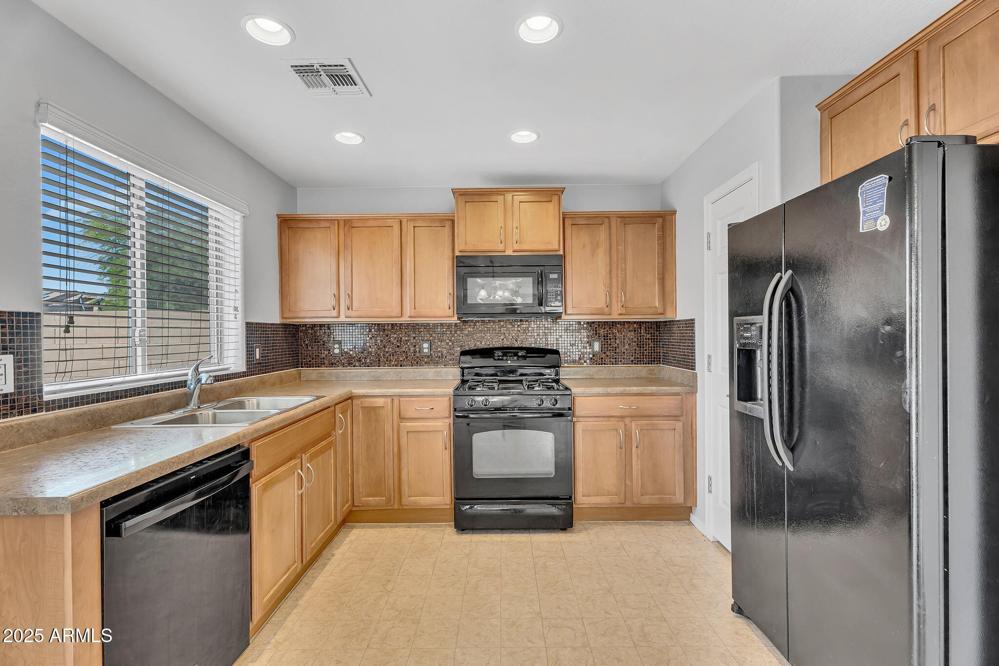 8071 West Georgetown Way Florence, AZ 85132 - Photo 12 of 43 a kitchen with a sink stove and refrigerator