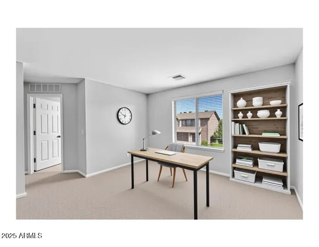 a living room with furniture and a book shelf