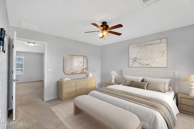 a bedroom with a bed and a chandelier