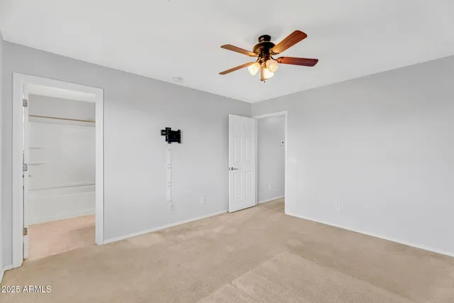 a view of a livingroom with a ceiling fan and window