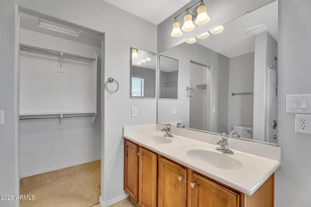 a bathroom with a sink vanity and a mirror