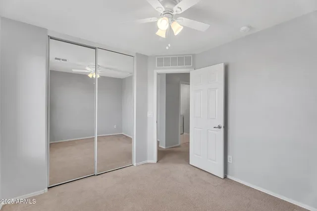 a view of an empty room with a fan