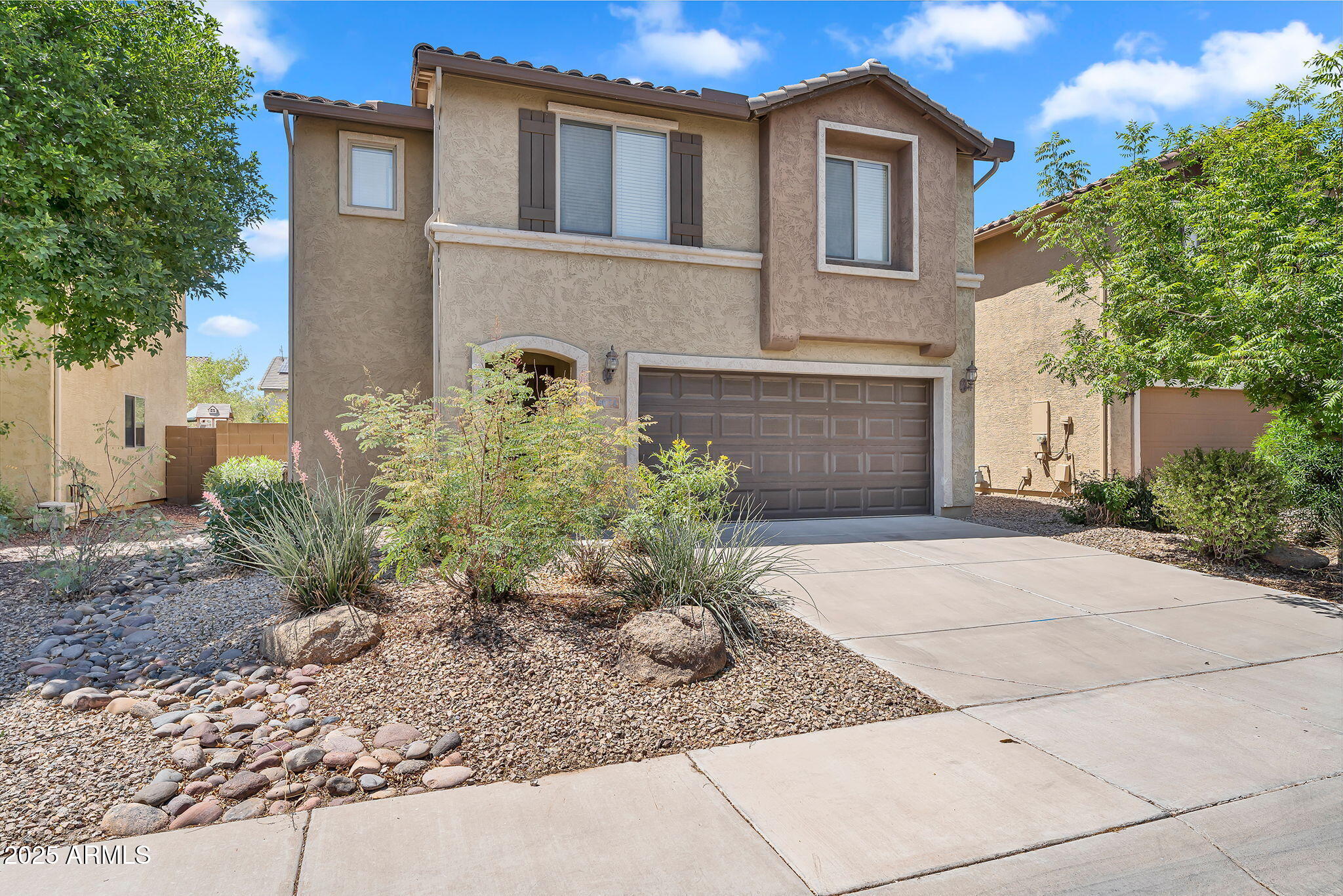 8071 West Georgetown Way Florence, AZ 85132 - Photo 3 of 43 a front view of a house with garden