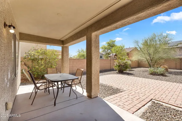 a view of a patio with a table chairs and a patio